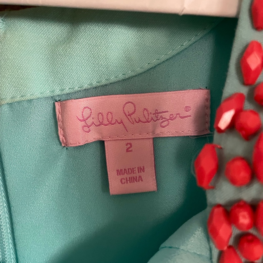 Lilly Pulitzer Turquoise Garment with Red Embellishments